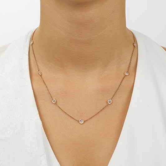 Rose gold necklace with round diamonds.