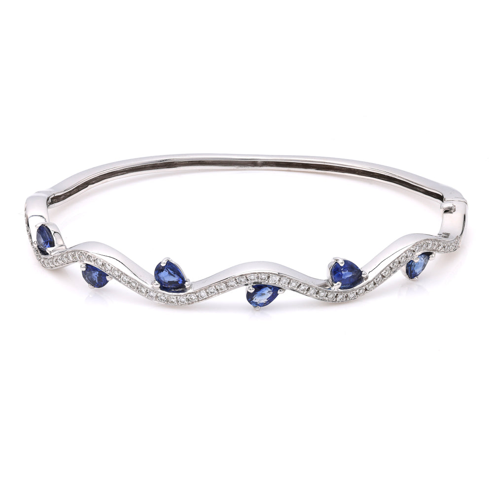 18K white gold bangle with pear sapphires.