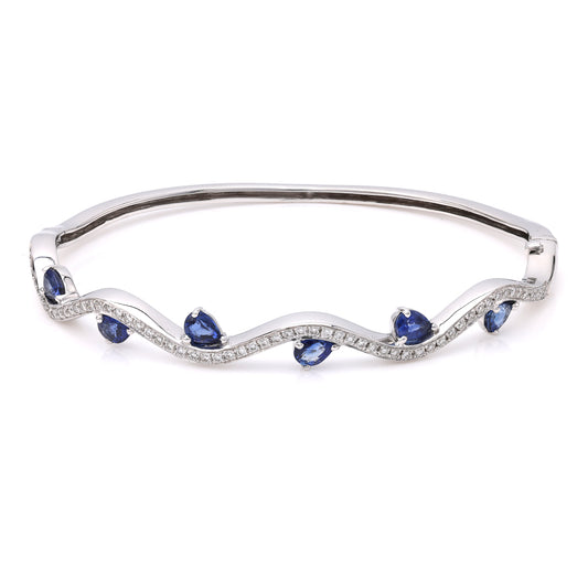 18K white gold bangle with pear sapphires.