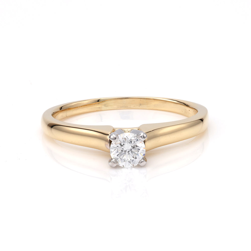 Gold band solitaire diamond engagement ring.