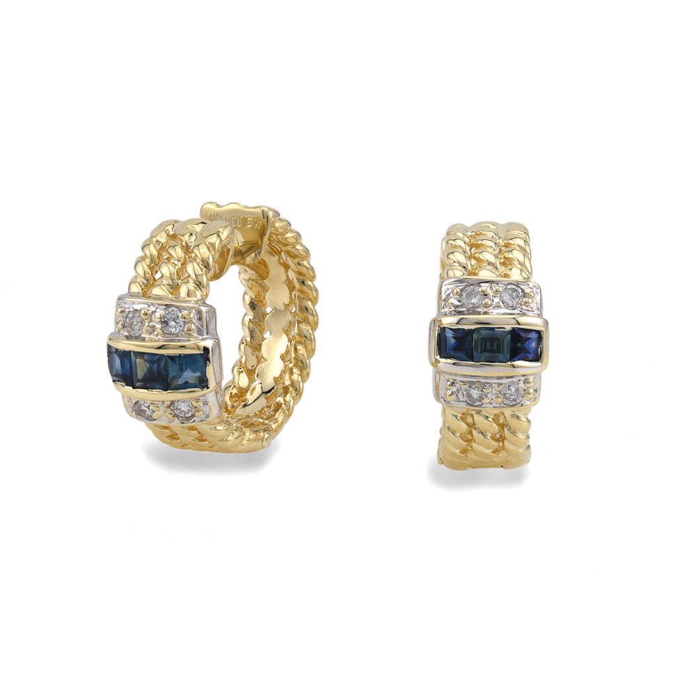 Gold huggie earrings with blue sapphires.