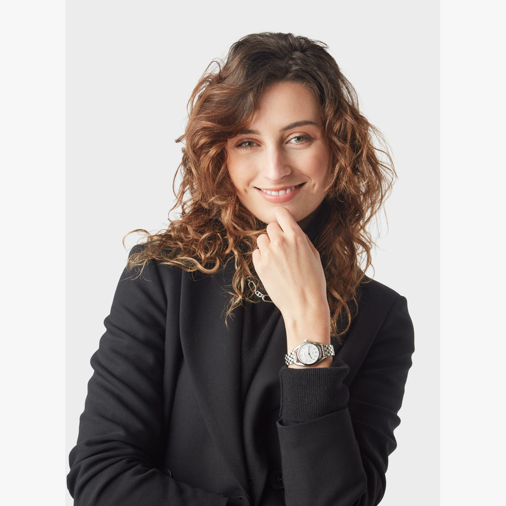 Woman wearing stainless steel SHINOLA watch.