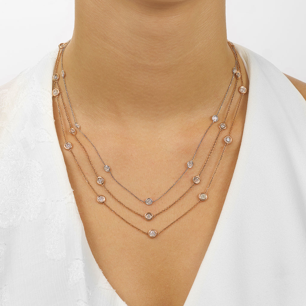 Rose gold necklace with round diamonds.