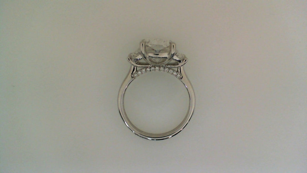 Three-stone cushion diamond engagement ring.