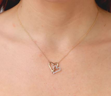 Two-tone heart necklace with round diamond.