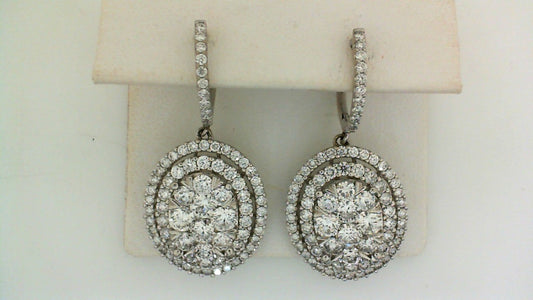 Round diamond drop earrings, white gold setting.