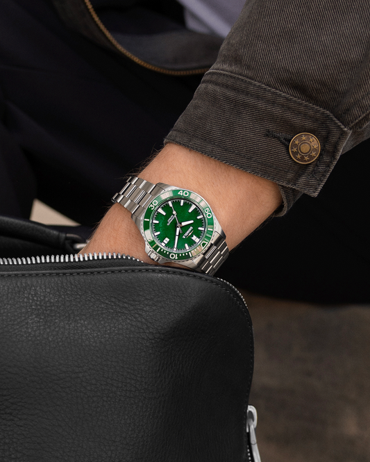 Green dial stainless steel men's watch.