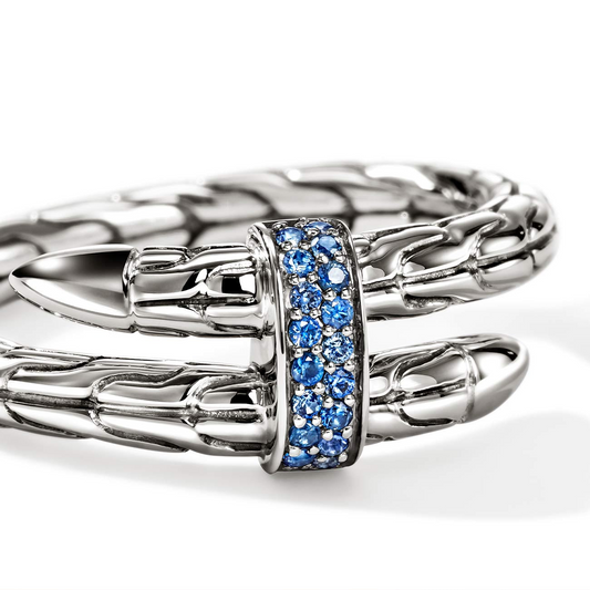 Sterling silver ring with blue sapphire accents.