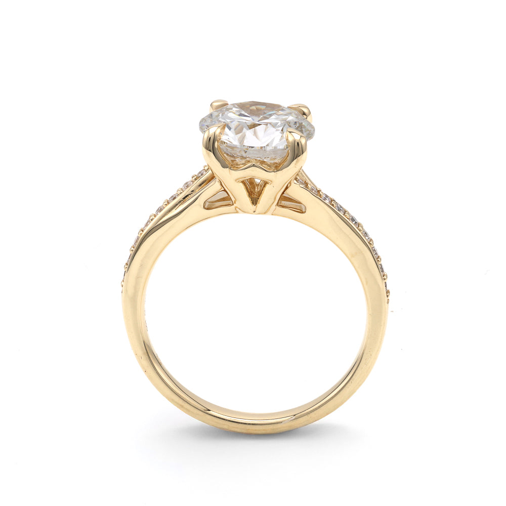 Yellow gold ring with round diamond centerpiece.