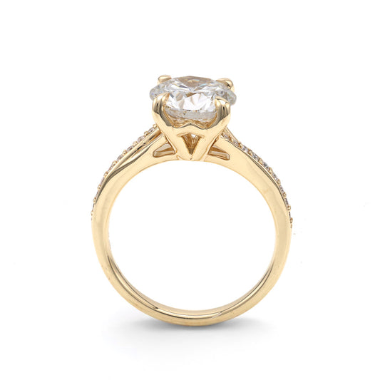 Yellow gold ring with round diamond centerpiece.