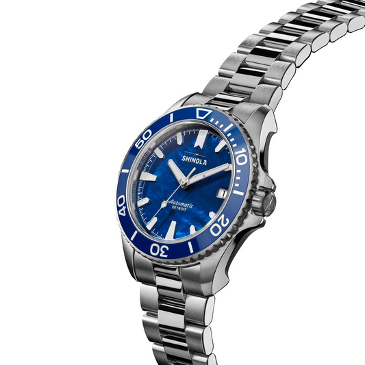 Blue mother of pearl dial, stainless steel band.