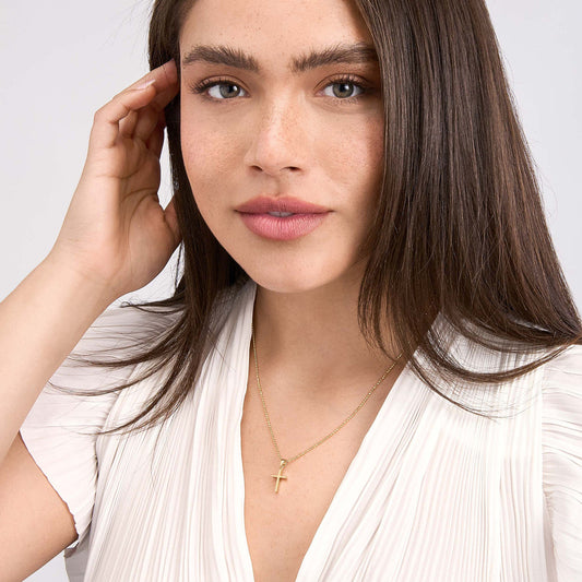 Dual-tone 14K gold cross necklace.