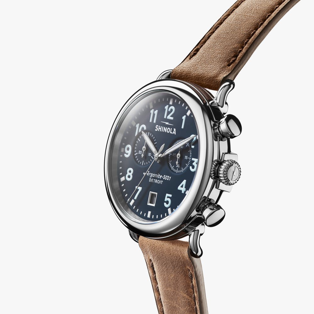 Blue dial chronograph watch with leather strap.