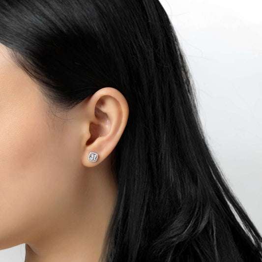 Cushion-cut simulated diamond earrings on ear.