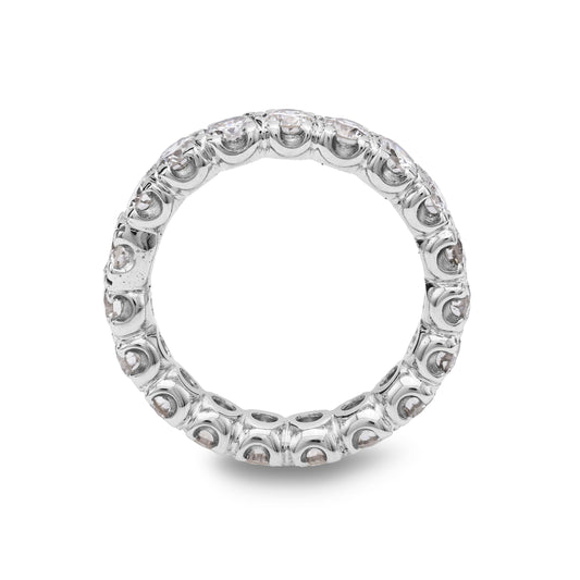 Platinum band with round diamonds, intricate setting.