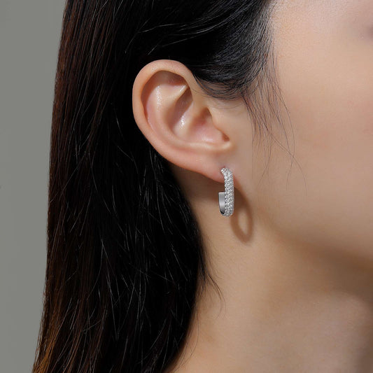Simulated diamond J Hoop earrings in silver.