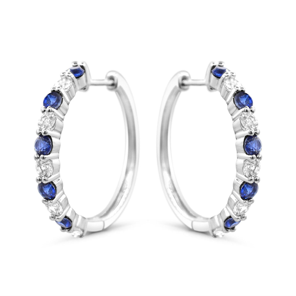Sterling silver hoops with blue sapphires.
