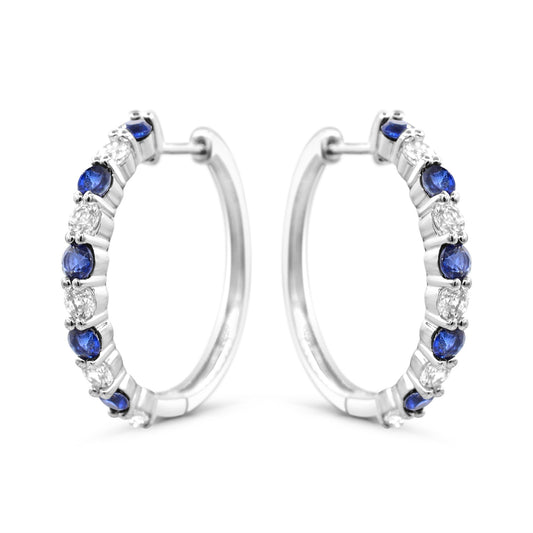 Sterling silver hoops with blue sapphires.