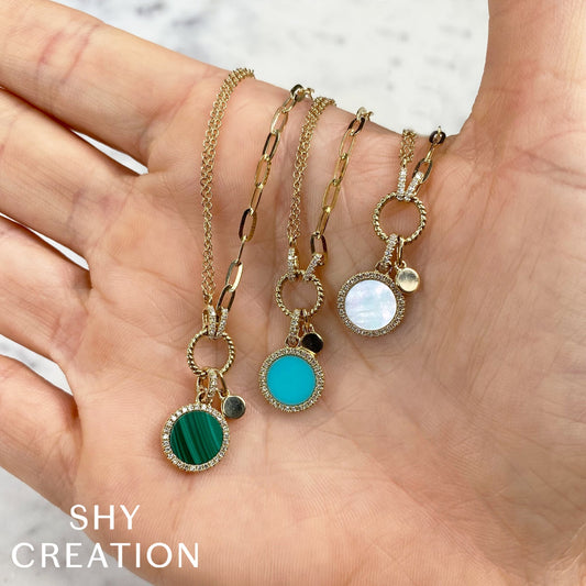 Yellow gold necklaces with colorful gemstone pendants.