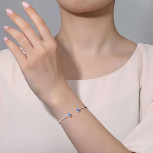 Platinum bangle with blue aquamarine stones.