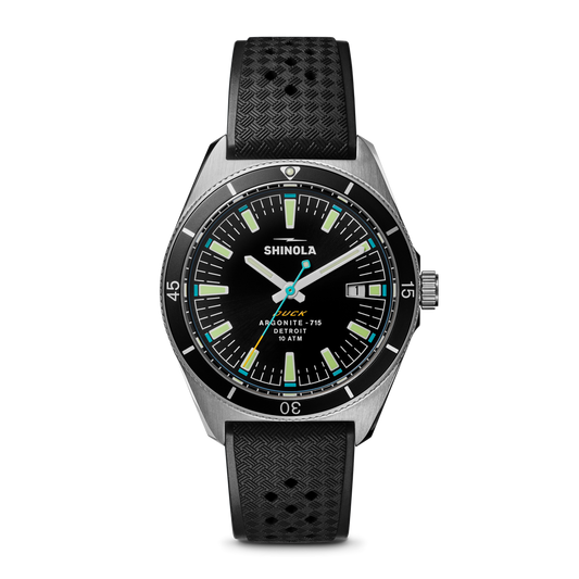 Black dial watch, stainless steel case, rubber strap.