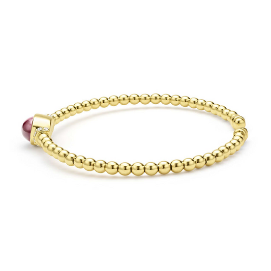 Gold cuff bracelet with rhodolite garnet.