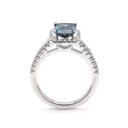 Blue diamond halo engagement ring in white gold.