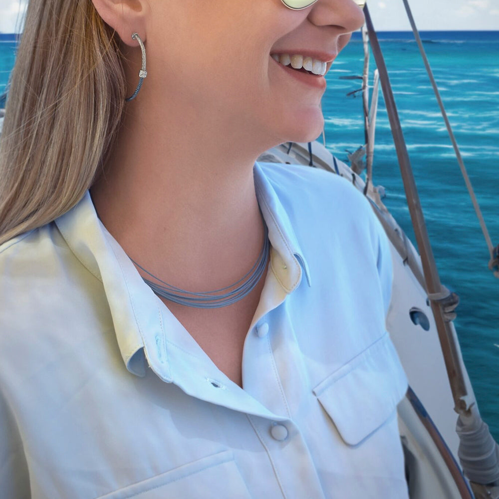 Stainless steel blue cable necklace on woman.