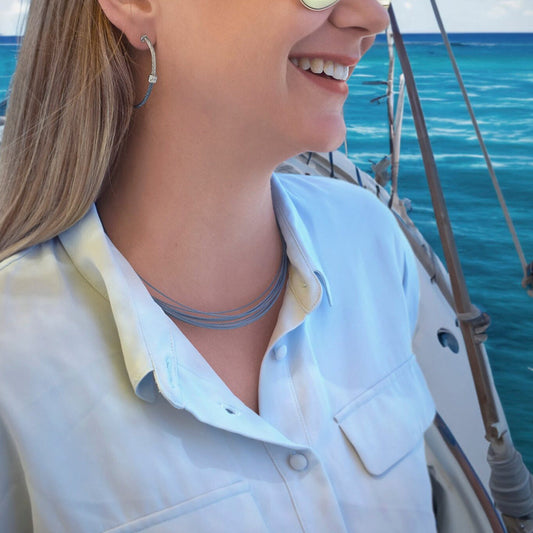 Stainless steel blue cable necklace on woman.