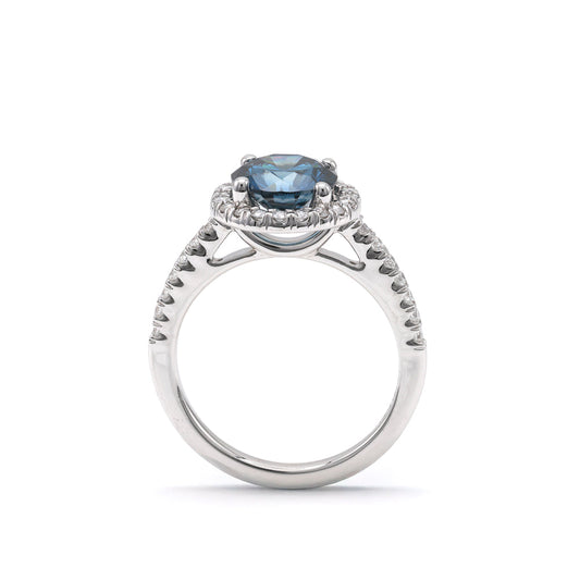 Blue diamond halo engagement ring in white gold.
