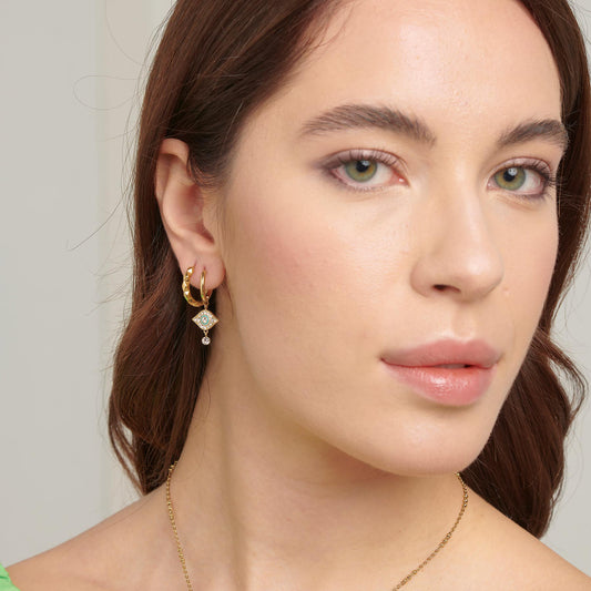 Gold-plated dangle earrings with yellow crystals.