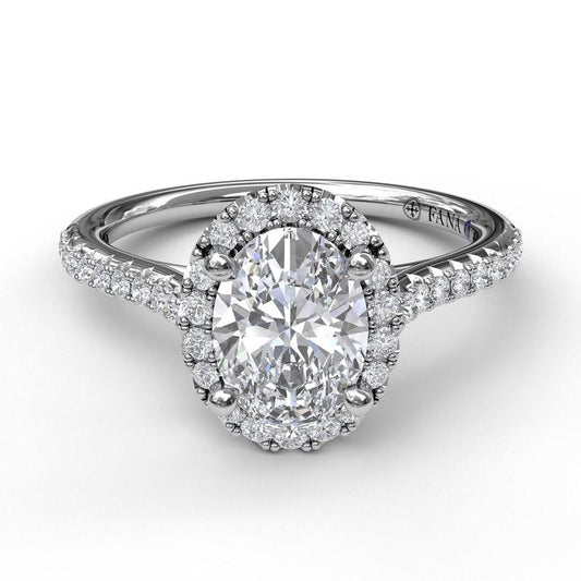 Oval diamond halo engagement ring in white gold.