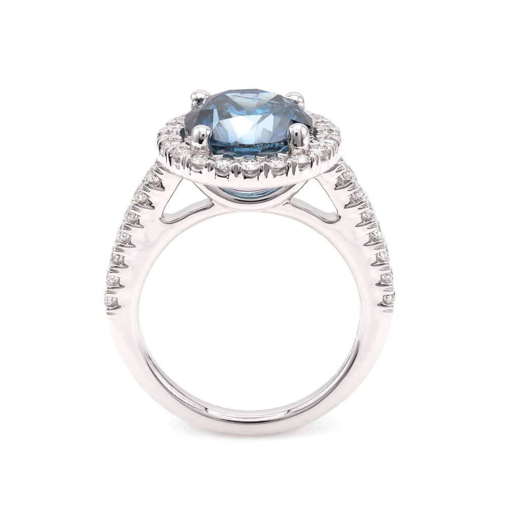 Blue diamond halo engagement ring in white gold.