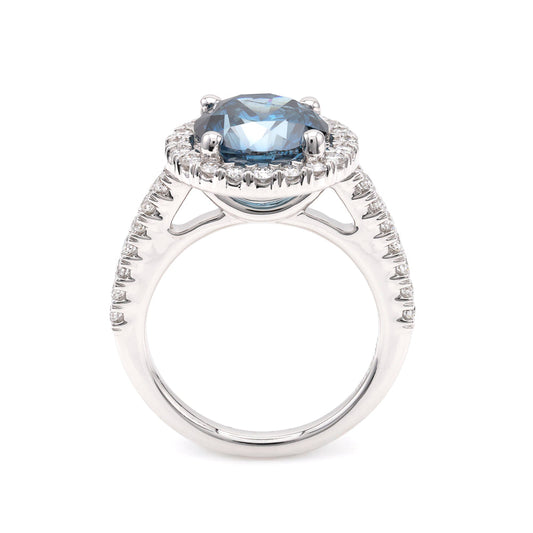 Blue diamond halo engagement ring in white gold.