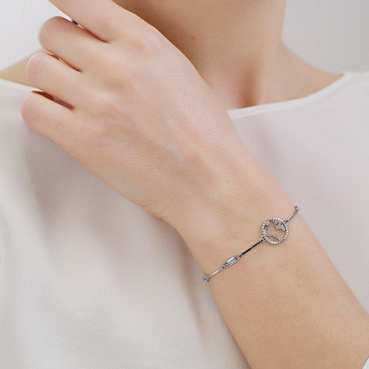 Simulated blue diamond bracelet on wrist.