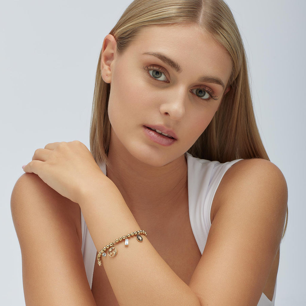 Yellow stainless steel bracelet with gemstone charms.
