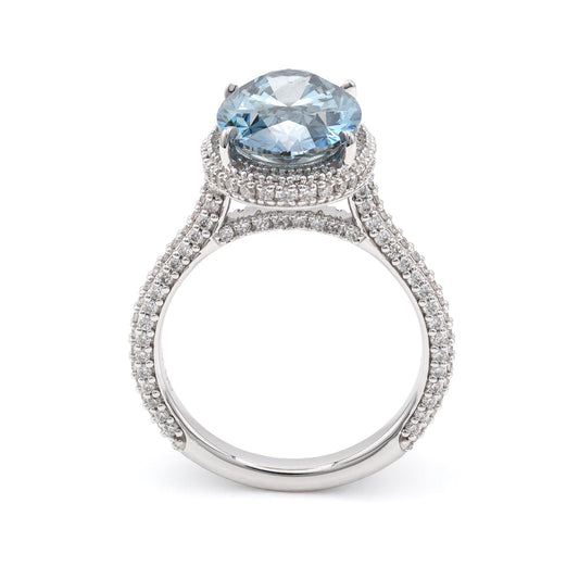 Halo engagement ring with blue oval diamond.
