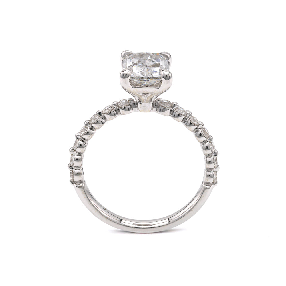 Radiant diamond ring with round accents.
