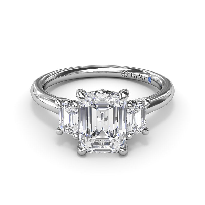 Three-stone emerald diamond white gold ring.