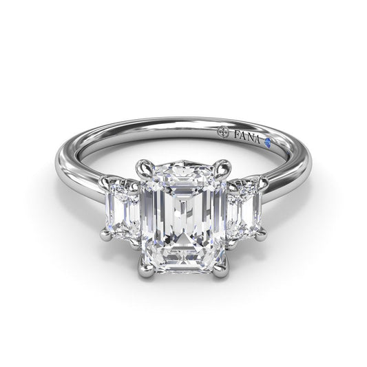 Three-stone emerald diamond white gold ring.