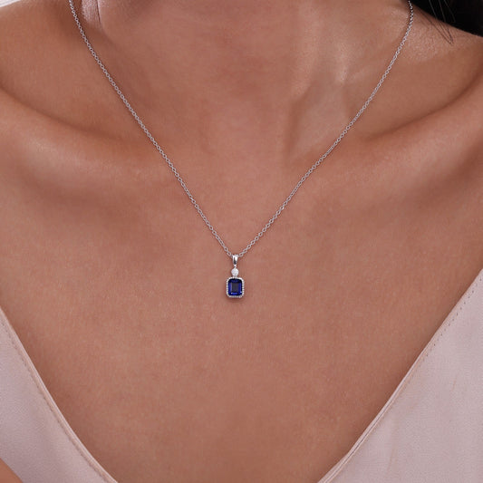 Simulated sapphire pendant on silver chain.