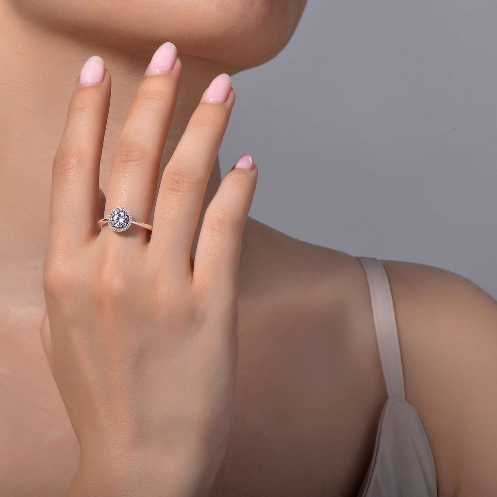 Halo simulated diamond ring on woman's hand.