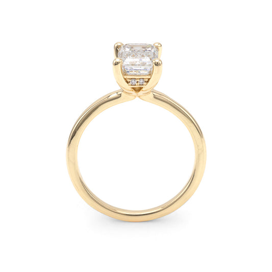 Yellow gold ring with emerald-cut diamond.