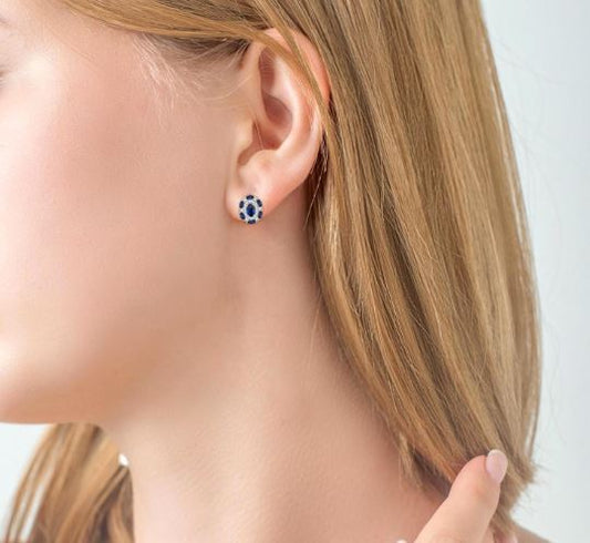 Oval sapphire stud earrings with diamonds.