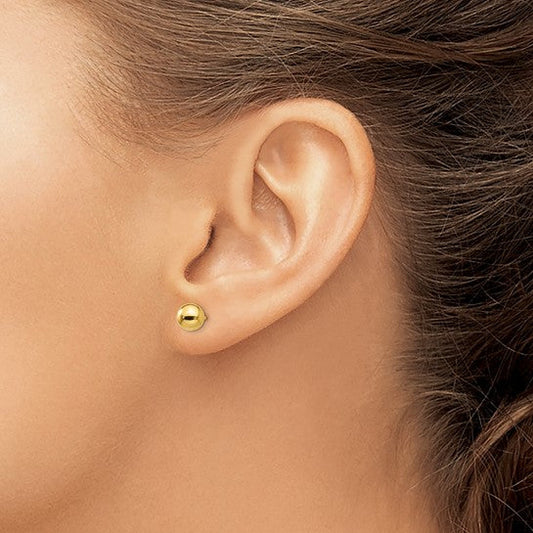 14K yellow gold stud earrings worn.