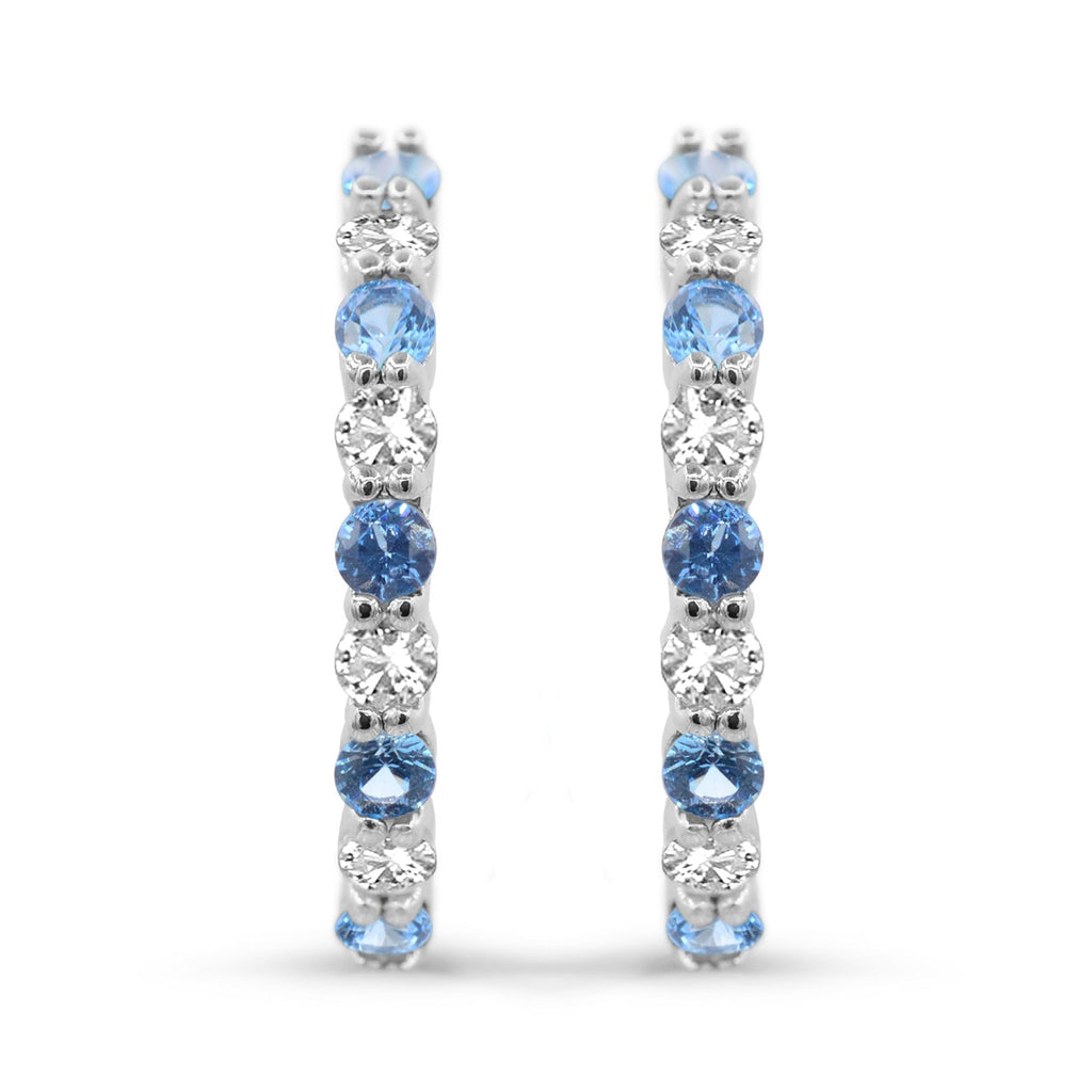 Sterling silver hoops with blue topaz stones.