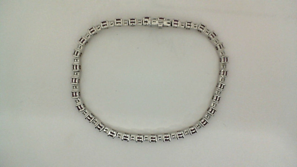 14K white bracelet with round rubies.