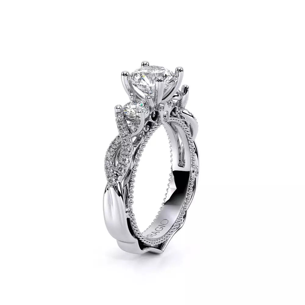 Three-stone diamond ring with intricate band design.
