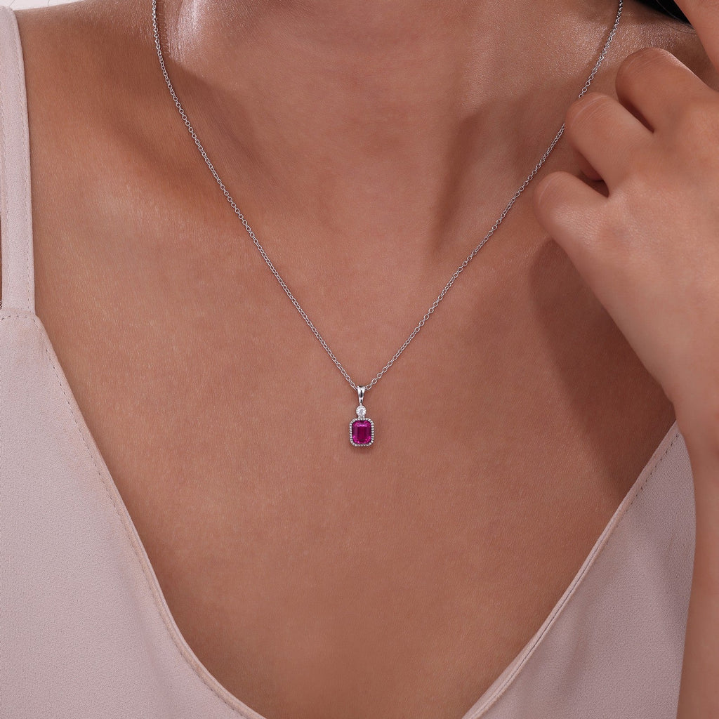 Simulated ruby pendant on silver chain.
