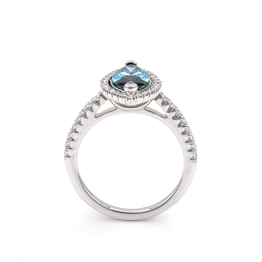 Blue diamond halo engagement ring in white gold.
